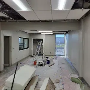 Commercial ceiling access opened during Vernon water damage repair